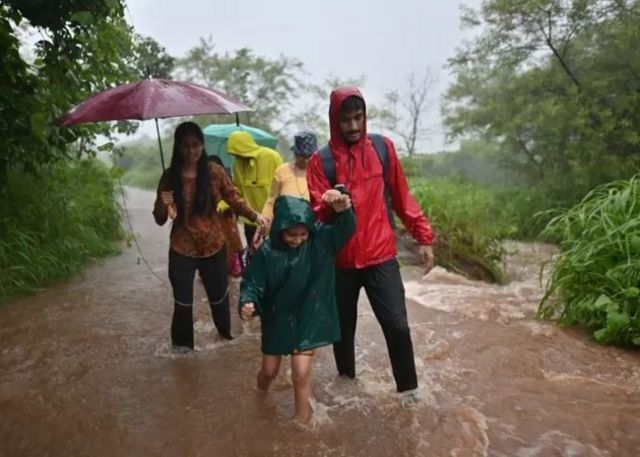 People moving through a flooded area.