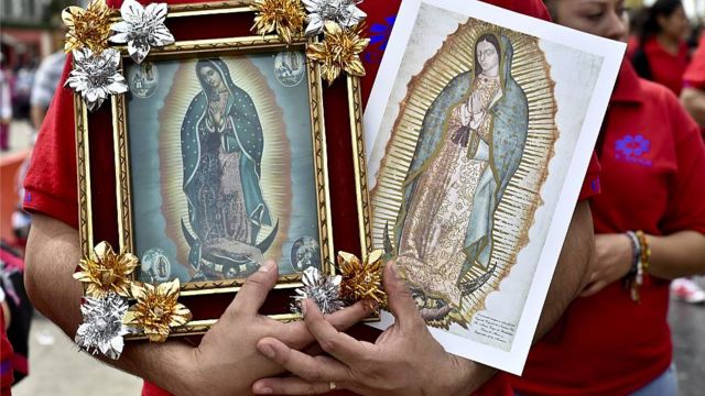 Fiel llevando láminas con la imagen de la Virgen de Guadalupe