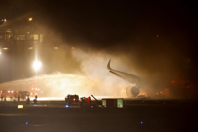 Bomberos intentando apagar un incendio en el aeropuerto de Haneda, Tokio.
