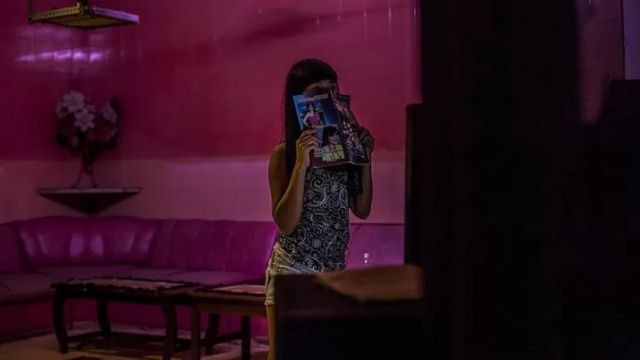 Foto ilustrasi: Menutup wajahnya, seorang PSK di kawasan 'lampu merah' Dolly, Surabaya, 19 Juni 2014.
