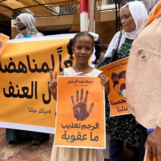 Protesters in Khartoum with posters saying 