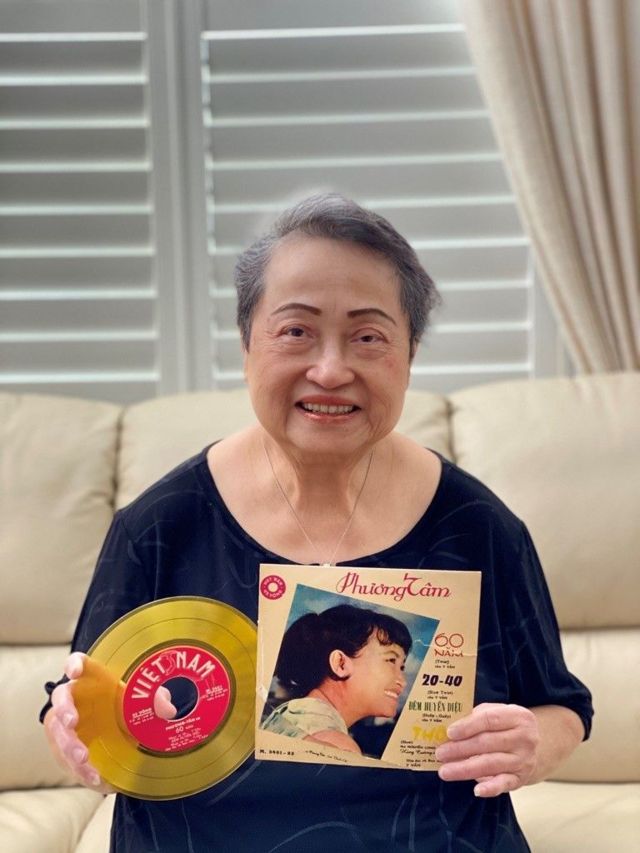 Phuong Tam holding album cover