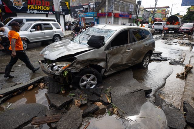 Autos destrozados en la vía y asfalto levantado por las fuertes lluvias. 