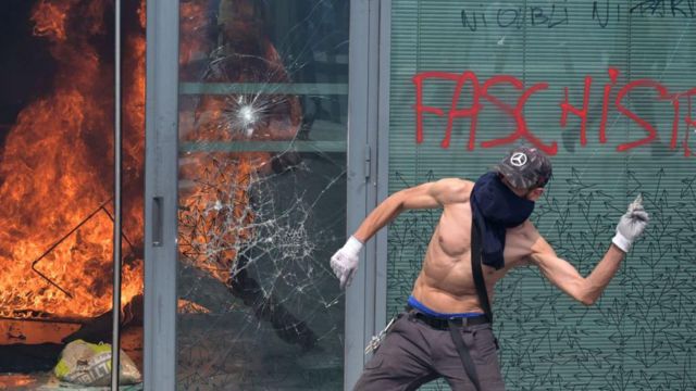 Image: https://ichef.bbci.co.uk/news/640/cpsprodpb/b83c/live/c3ccef60-1759-11ee-8975-7f42b3a48461.jpg Un manifestante se enfrenta a la polica durante una marcha de conmemoracin de un conductor adolescente asesinado a tiros por un polica en el suburbio parisino de Nanterre el 29 de junio de 2023