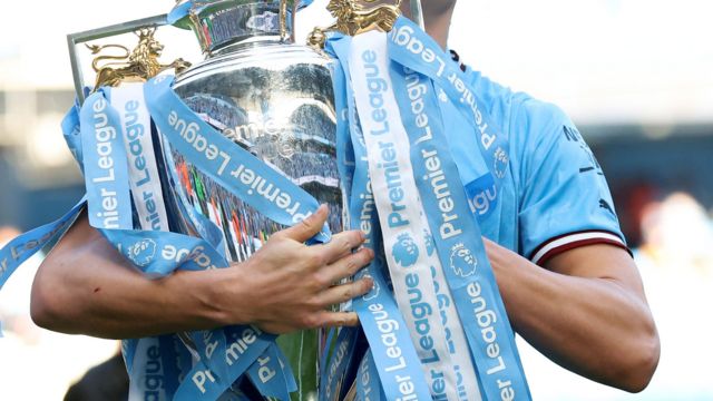 Manchester City's Erling Haaland holds the Premier League trophy