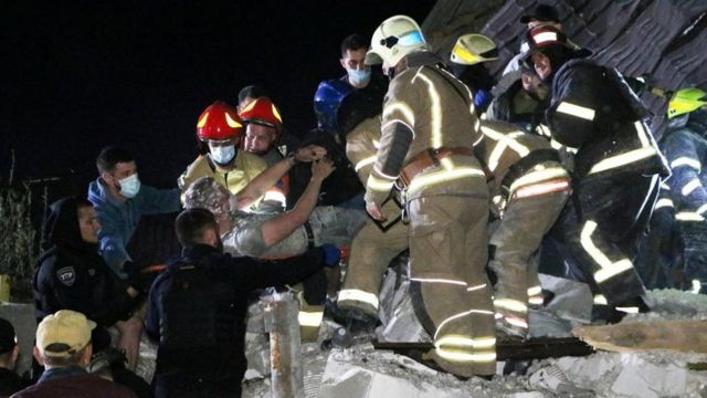 نیروهای امدادی و اورژانس مردی را از زیر آوار ساختمانی در اوکراین نجات می‌دهند