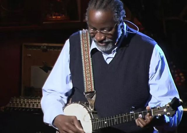 John Francis playing his banjo at the start of his TED talk.