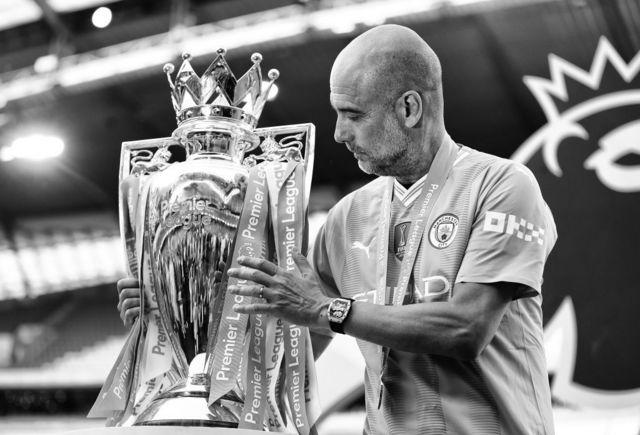 Pep Guardiola with the Premier League trophy
