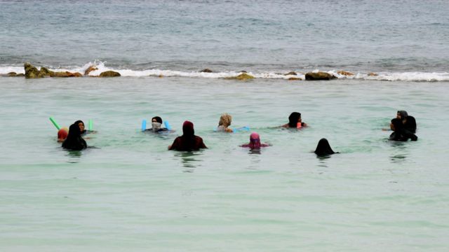 A group of women swimming in Maldives 