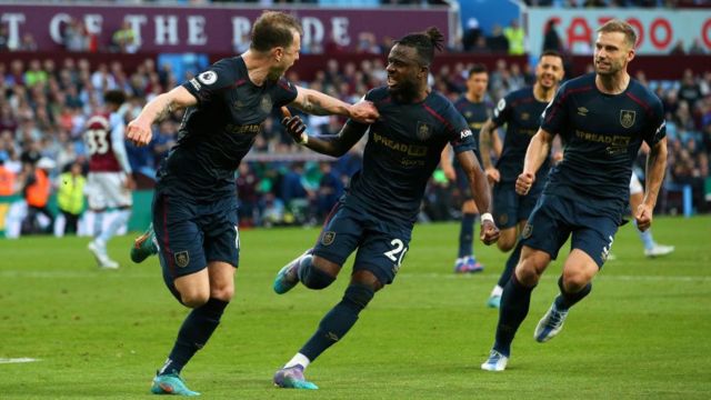 Burnley players celebrate scoring at Aston Villa