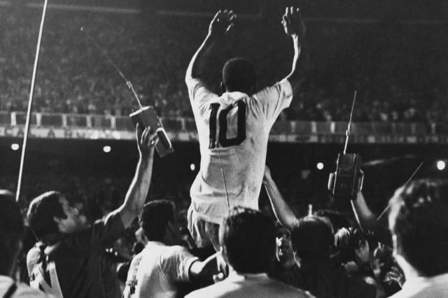 Pelé is held aloft following his 1,000th professional goal in 1969.