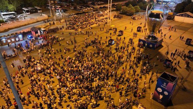 An aerial view of football fans gathering around the huge model of UCL trophy at Taksim Square after the Champions League final
