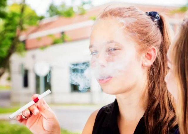A girl holding an electronic cigarette
