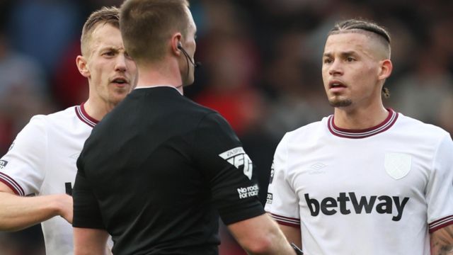 Kalvin Phillips speaks to a referee