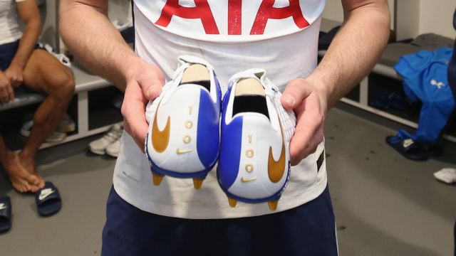 Harry Kane receives a pair of Nike boots to celebrate his 100th Premier League goal