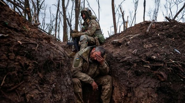 Ukrainian servicemen rest at their positions after a fight