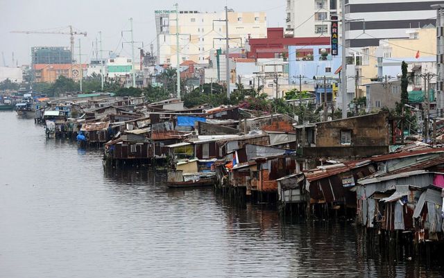 poor housing conditions by canal in HCMC