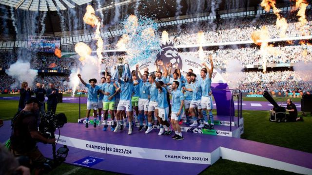 Kyle Walker of Manchester City lifts the Premier League trophy with team mates for a record fourth consecutive time during the Premier League match between Manchester City and West Ham United at Etihad Stadium