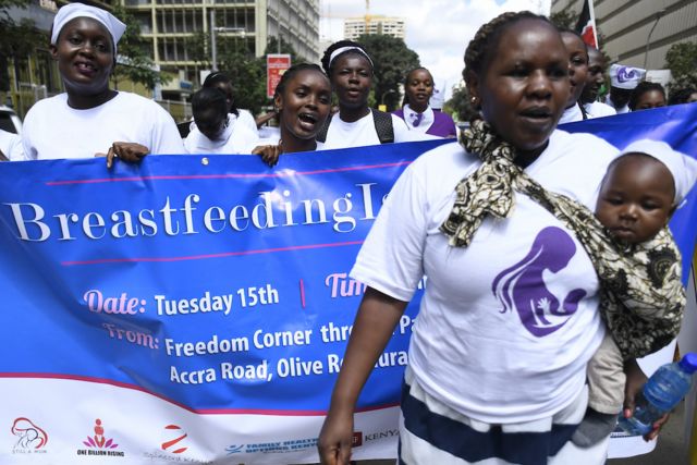 A group of protesters march towards a restaurant after a female client was allegedly thrown out for breastfeeding and not covering up in Nairobi's Central Business District on 15 May 2018. 