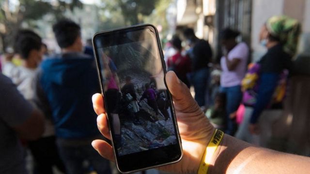 Un migrante viendo su teléfono