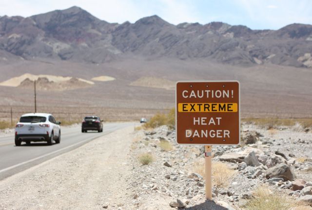 تظهر علامة تحذير من الحرارة على طول الطريق السريع بالولايات المتحدة أثناء موجة حر في حديقة وداي الموت الوطنية، كاليفورنيا، في 16 يوليو/تموز 2023