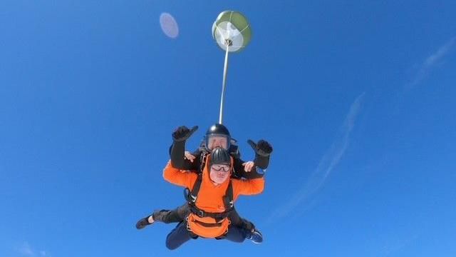 Teen and skydrive instructor mid skydive 