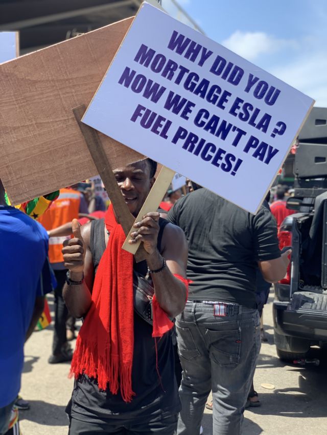 Ghana protestor dey hold placard