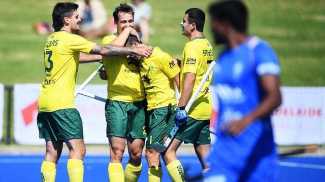 Australian players celebrate scoring a goal against India in Adelaide