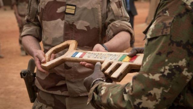 French Colonel Faivre hands over the symbolic key of Camp Barkhane to the Malian colonel during the transfer ceremony of the Barkhane military base to the Malian army in Timbuktu, December 14, 2021.