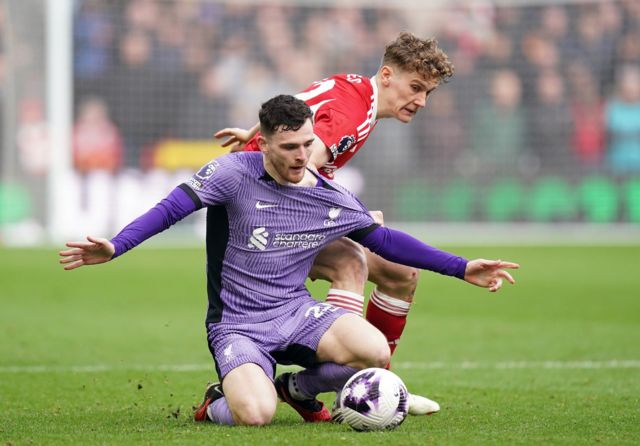 Liverpool's Andrew Robertson shields the ball from Nottingham Forest's Ryan Yates