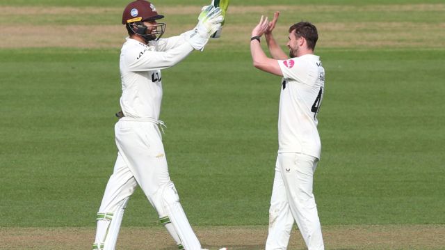 Cameron Steel celebrates taking a wicket with Ben Foakes