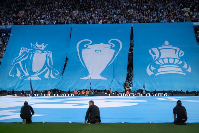 Banners at Etihad Stadium showing Manchester City's Treble