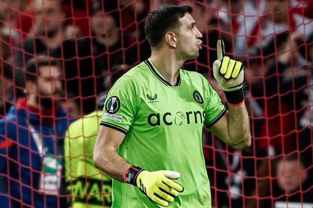 Aston Villa goalkeeper Emiliano Martinez puts his finger to his lips as if to 'shush' the home fans during their penalty shootout win over Lille