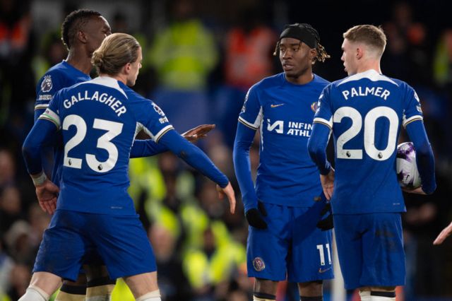 Chelsea's players argue over who takes a penalty against Everton