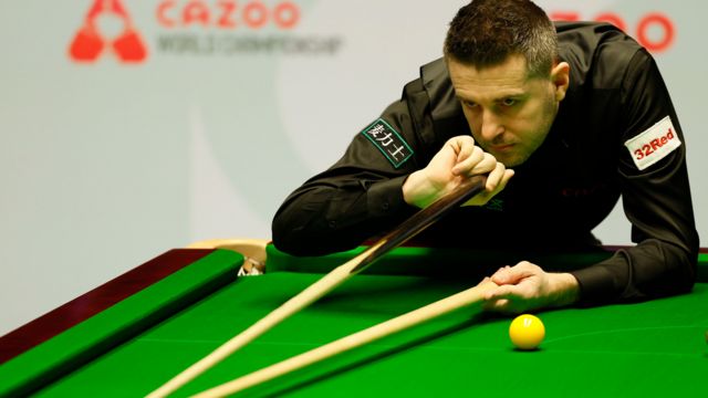 Mark Selby plays a shot with the rest