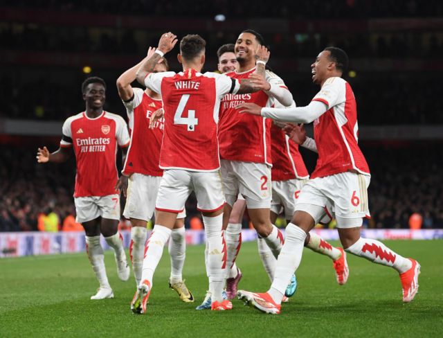 Arsenal players celebrate goal against Chelsea