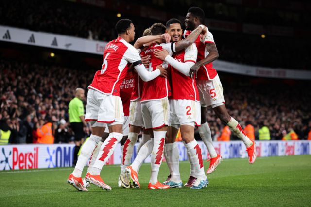 Arsenal players celebrate goal against Chelsea