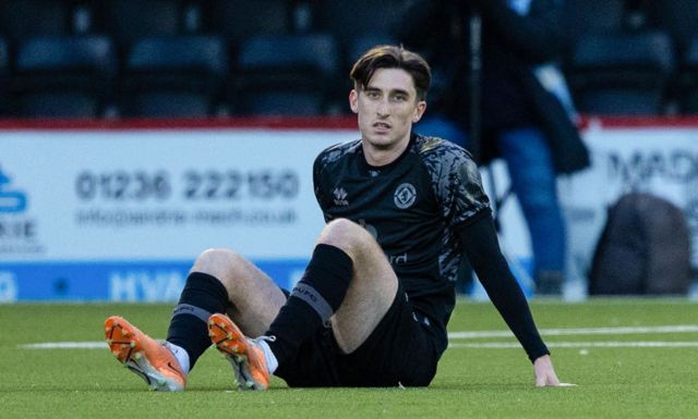 Dundee United's Chris Mochrie goes down injure during a cinch Championship match between Airdrionians and Dundee United at Excelsior Stadium, on April 26, 2024, in Airdrie, Scotland.