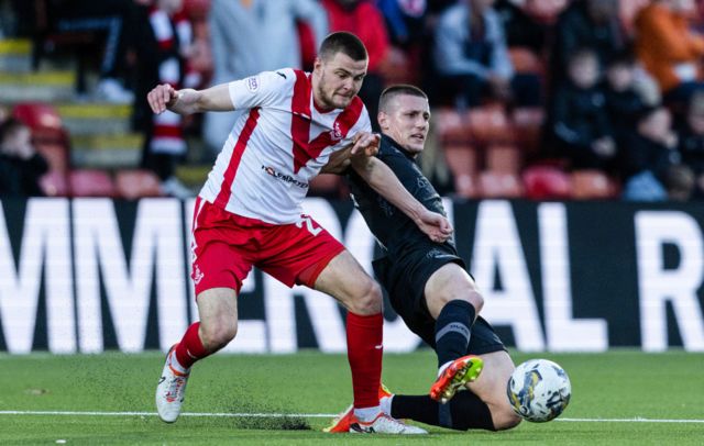 Airdrie's Gabby McGill (L) and Dundee United's Sam McClelland in action during a cinch Championship match between Airdrionians and Dundee United at Excelsior Stadium, on April 26, 2024, in Airdrie, Scotland.