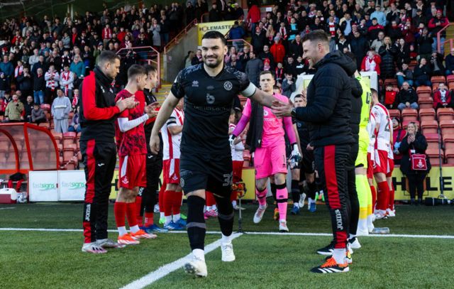 Dundee United's Tony Watt leads his team out through a guard of honour during a cinch Championship match between Airdrionians and Dundee United at Excelsior Stadium, on April 26, 2024, in Airdrie, Scotland.