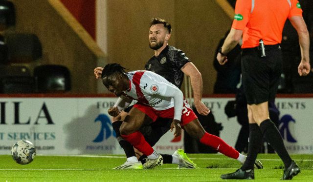 Airdrie's Kanayo Megwa and Dundee United's Scott McMann in action during a cinch Championship match between Airdrionians and Dundee United at Excelsior Stadium, on April 26, 2024, in Airdrie, Scotland.