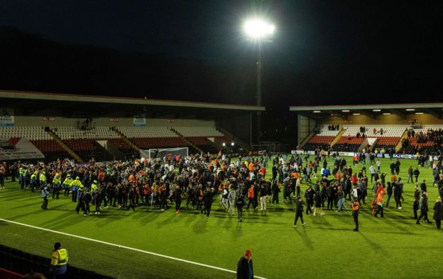 Dundee United fans invade the pitch as they win the cinch Championship title during a cinch Championship match between Airdrionians and Dundee United at Excelsior Stadium, on April 26, 2024, in Airdrie, Scotland.