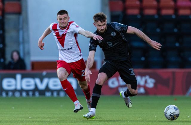 Airdrie's Gabby McGill (L) and Dundee United's Scott McMann in action during a cinch Championship match between Airdrionians and Dundee United at Excelsior Stadium, on April 26, 2024, in Airdrie, Scotland.