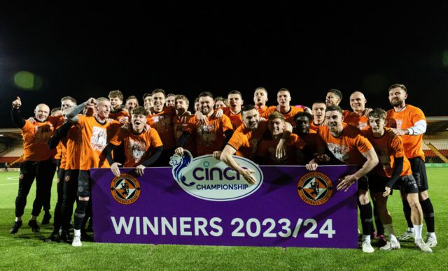 Dundee United players and staff celebrate winning the cinch Championship title during a cinch Championship match between Airdrionians and Dundee United at Excelsior Stadium, on April 26, 2024, in Airdrie, Scotland.
