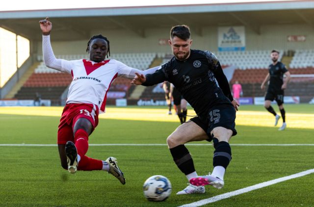 Dundee United's Glenn Middleton (R) and Airdrie's Kanayo Megwa in action during a cinch Championship match between Airdrionians and Dundee United at Excelsior Stadium, on April 26, 2024, in Airdrie, Scotland.