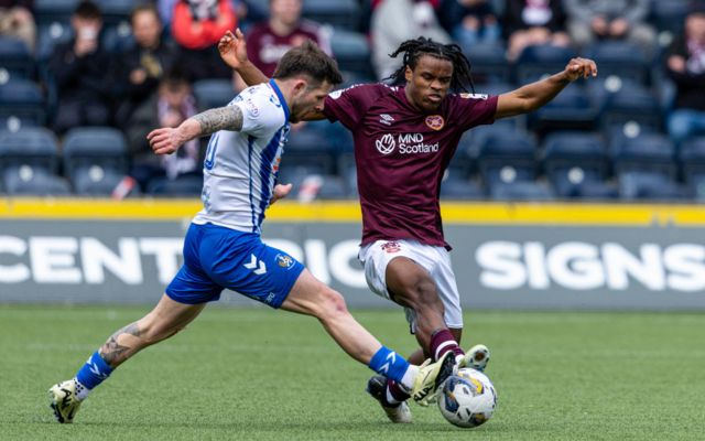 Kilmarnock's Matty Kennedy and Hearts' Dexter Lembikisa in action during a cinch Premiership match between Kilmarnock and Heart of Midlothain at Rugby Park, on April 27, 2024, in Kilmarnock, Scotland.