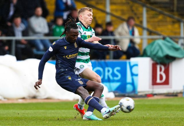 Dundee's Malachi Boateng and Celtic's Alistair Johnston in action during a cinch Premiership match between Dundee and Celtic at Scot Foam Stadium at Dens Park, on April 28, 2024, in Dundee, Scotland.
