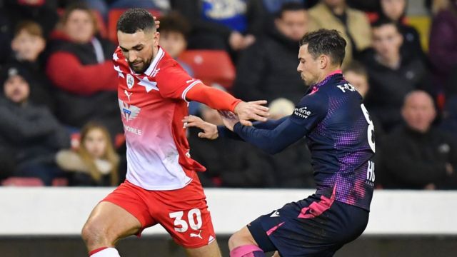Barnsley midfielder Adam Phillips and Stevenage player Jake Forster-Caskey in action at Oakwell