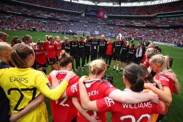 Manchester United players and staff in a huddle at the 2023 Women's FA Cup final