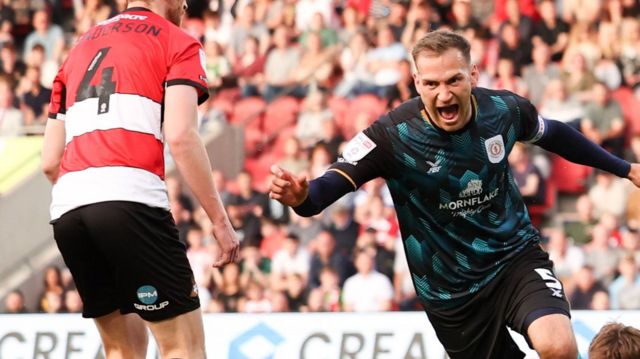 Mickey Demetriou celebrates